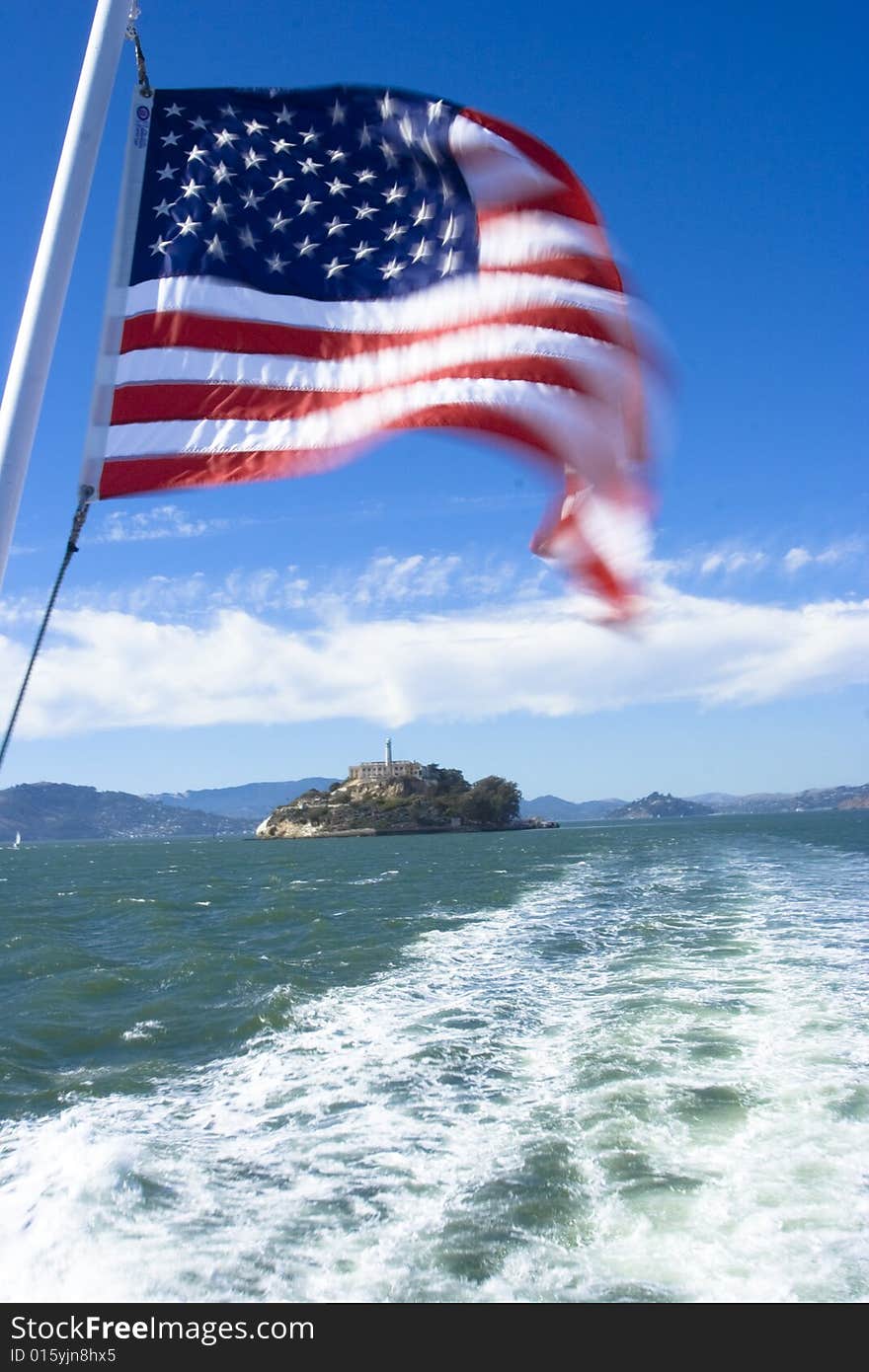 A american flag with alcatraz in the background