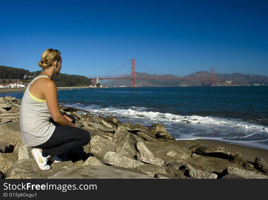 A woman staring at a bridge. A woman staring at a bridge