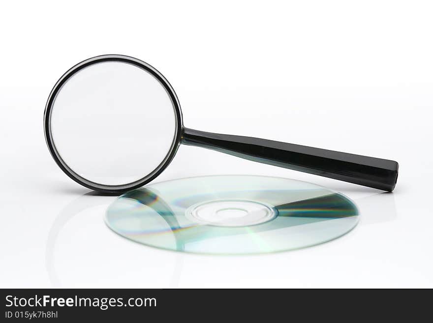 Searching on CD - magnifying glass and CD on light background