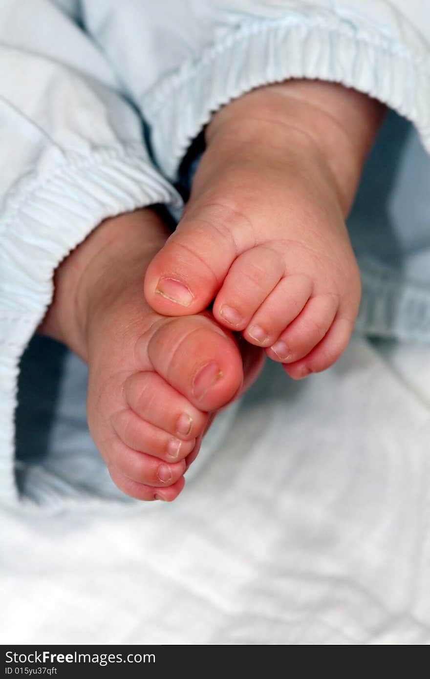 Close up of baby feet in pale pastels. Close up of baby feet in pale pastels