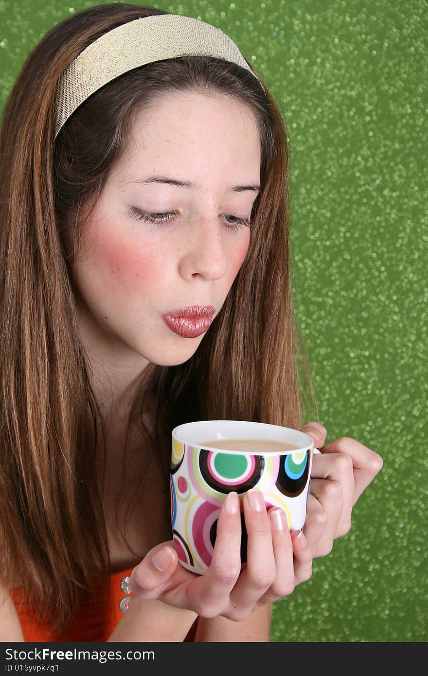 Brunette teenager on a green background wearing a broad head band. Brunette teenager on a green background wearing a broad head band