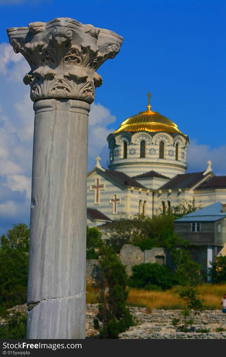 Column and church of the Chersonese on a sky background