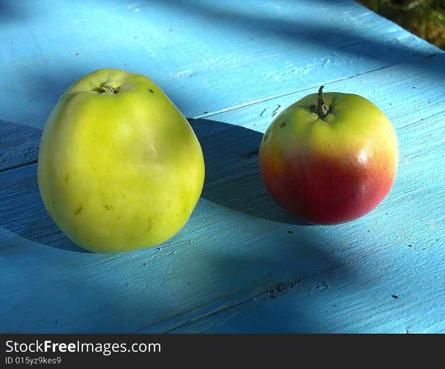 Two apples on blue table