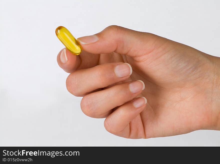 Lady's hand with a gel vitamin. Lady's hand with a gel vitamin