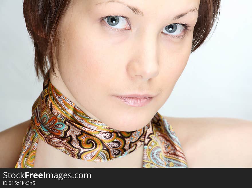 Portrait of a beautiful young woman with neckscarf