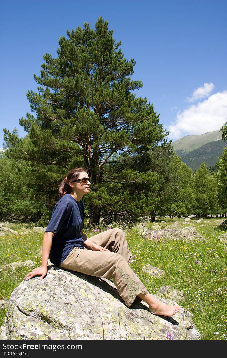 Barefoot Girl Sitting On Big Stone