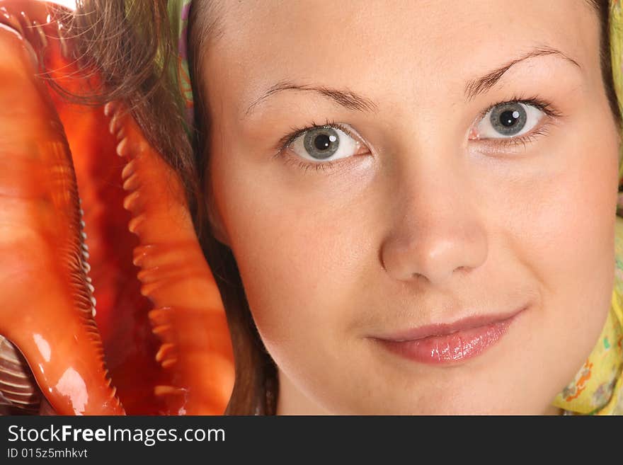 Portrait of Beautiful model with green headscarf and red sea shell