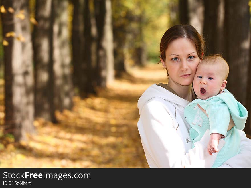 Mother and baby in the autumnal park