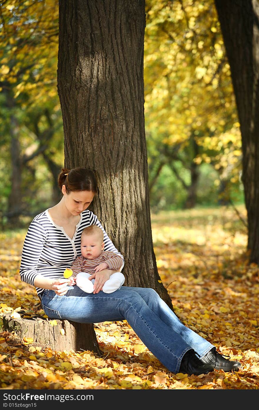 Mother and baby in the autumnal park