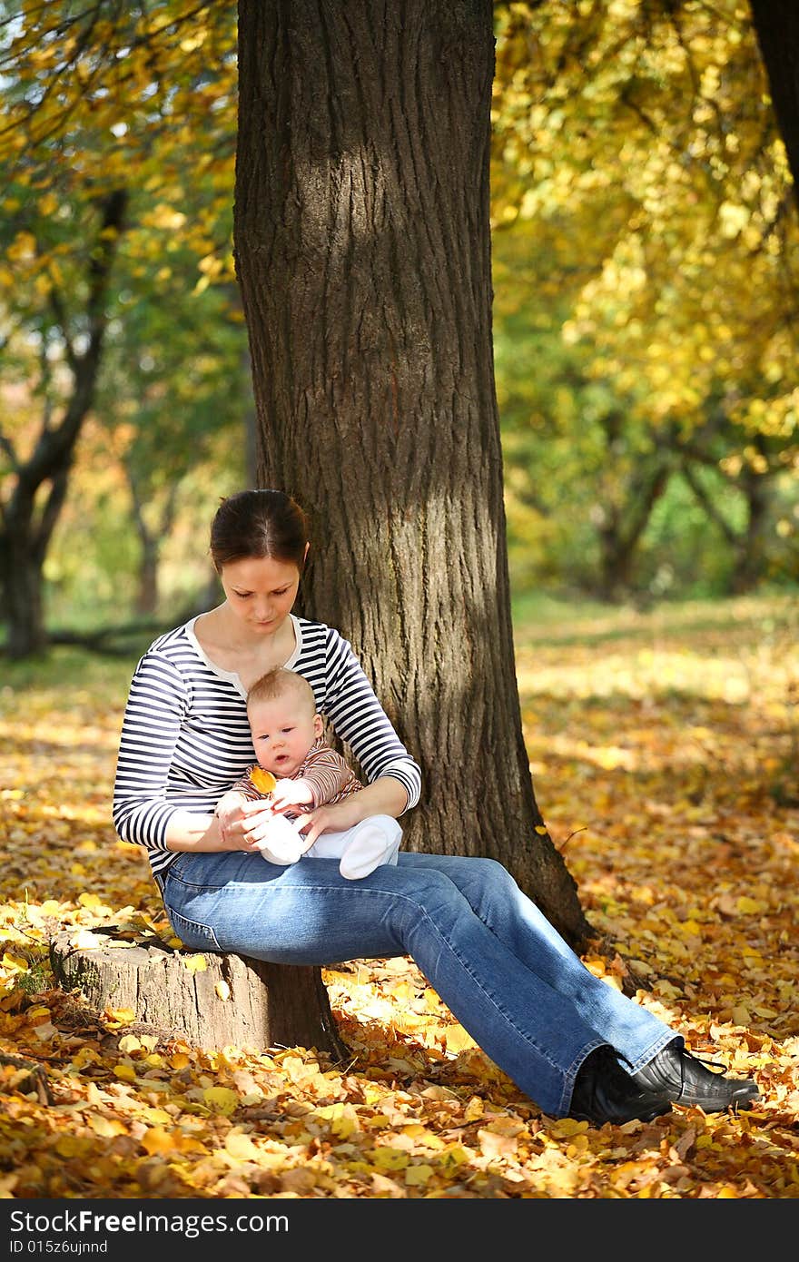 Mother and baby in the autumnal park