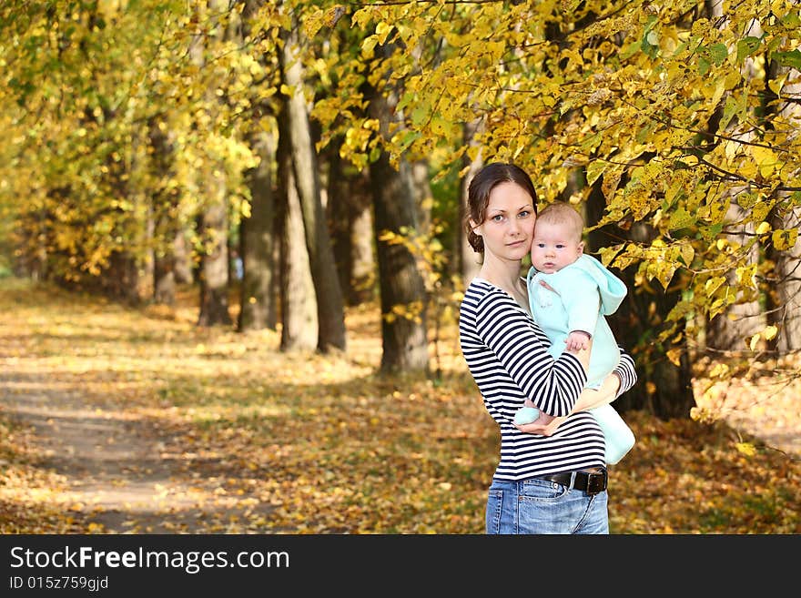 Mother and baby in the autumnal park