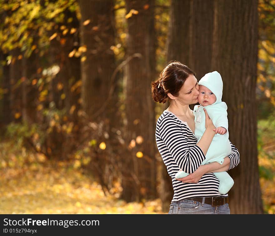 Mother and baby in the autumnal park