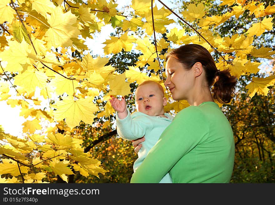 Mother and baby in the autumnal park