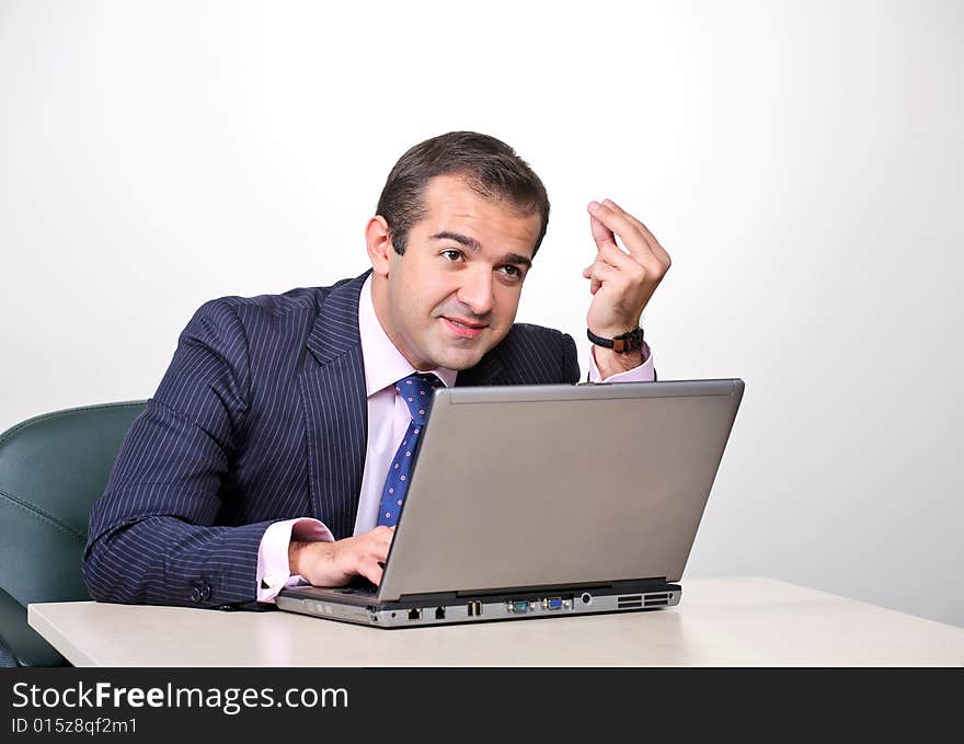 Emotional businessman working on laptop