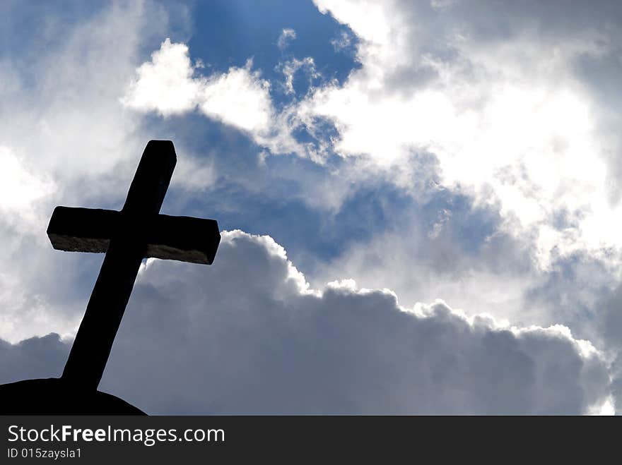 Iron cross against blue shining sky