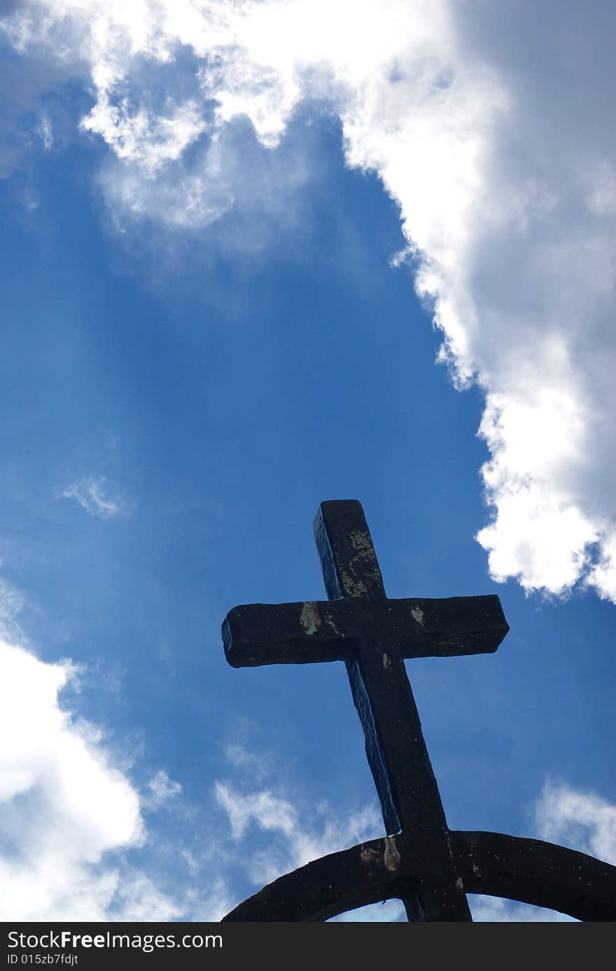 Iron cross against blue shining sky