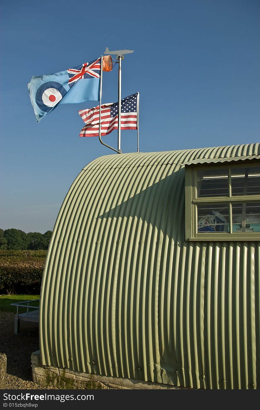 The allied flags fly over a wartime military building. The allied flags fly over a wartime military building