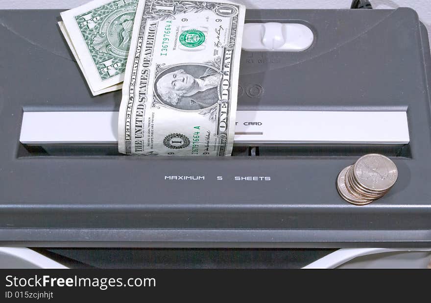 Paper shredder with dollar bills and coins ready to shred. Paper shredder with dollar bills and coins ready to shred