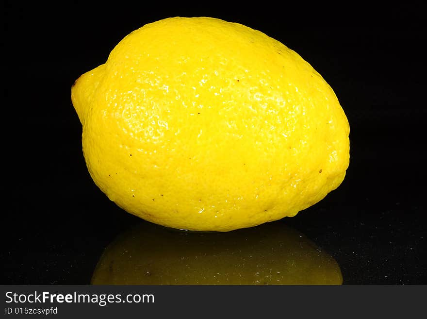 Bright lemon yellow juicy fruit on a dark background