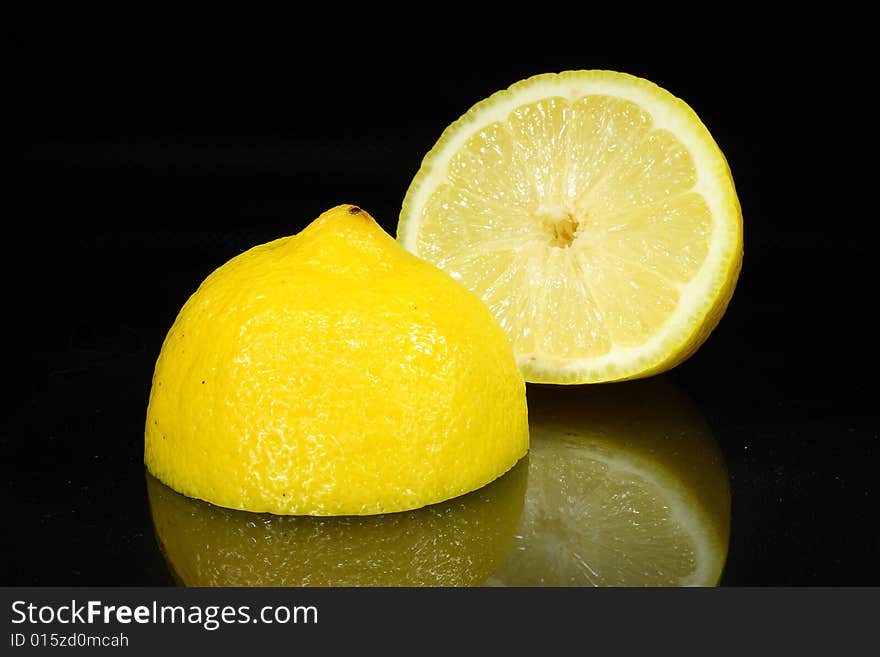 Bright lemon yellow juicy fruit on a dark background