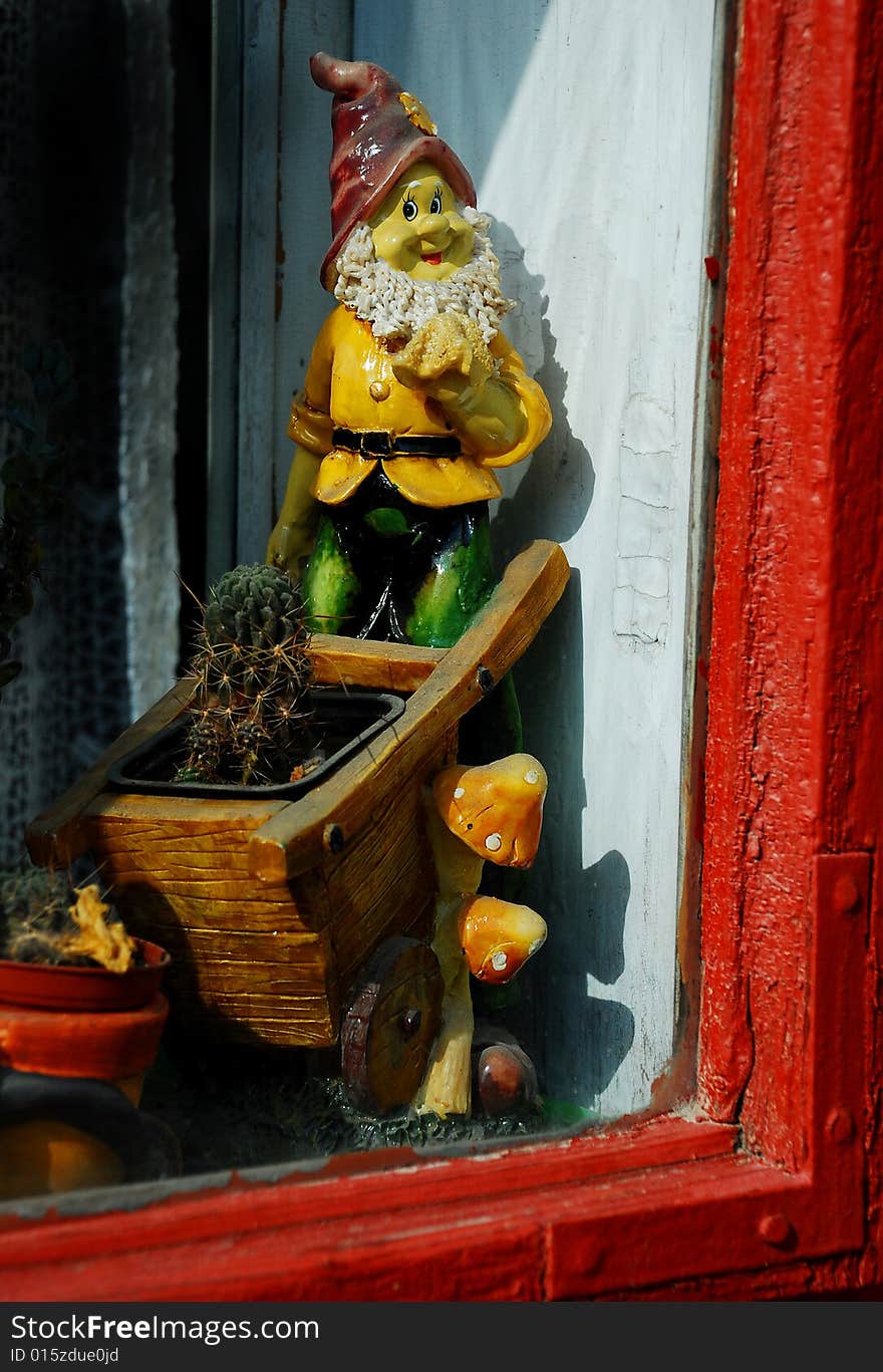 Dwarf with cactus inside a window