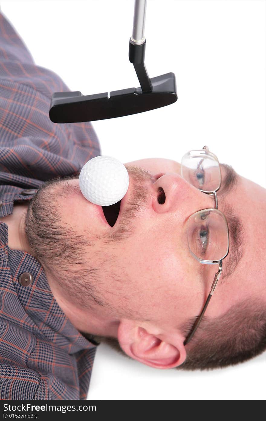 Lying man holds in mouth ball for golf