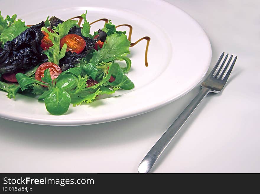 Green salad on a white plate