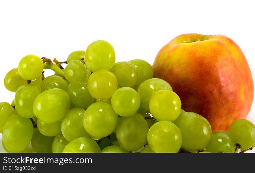 Green grapes and red apple closeup