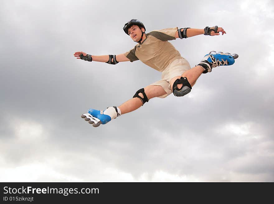 Roller jumping on grey sky