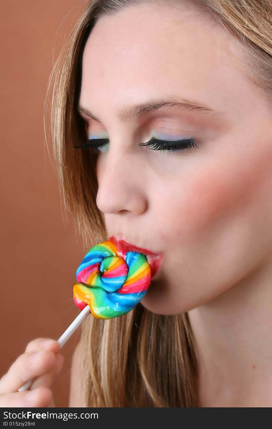 Beautiful young female model with swirl lolly. Beautiful young female model with swirl lolly