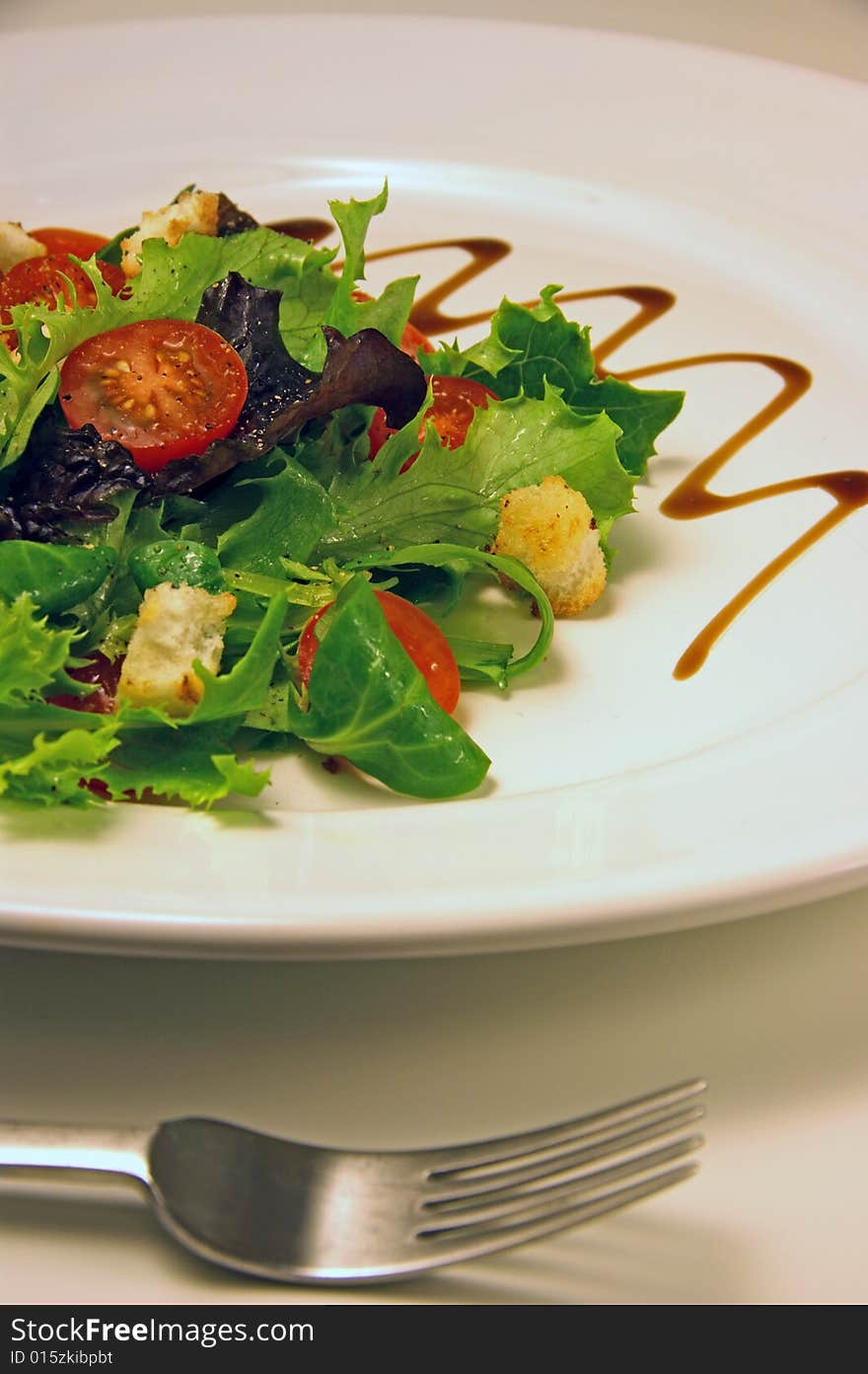 Green salad on a white plate