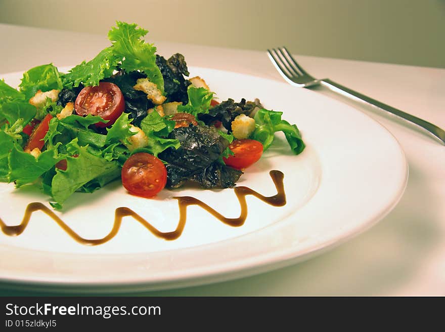 Green salad on a white plate