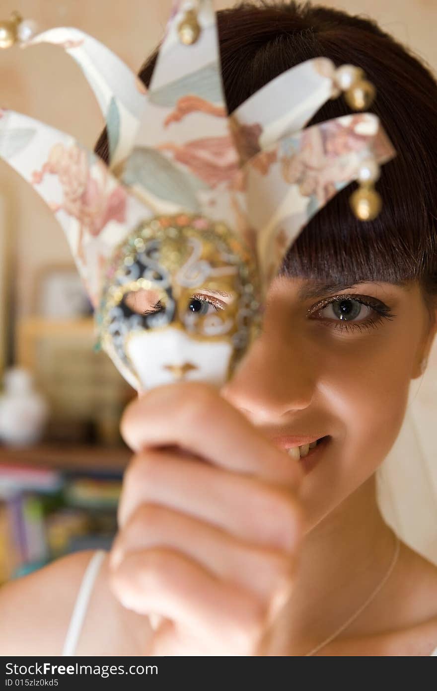 Happy bride with the mask is smiling