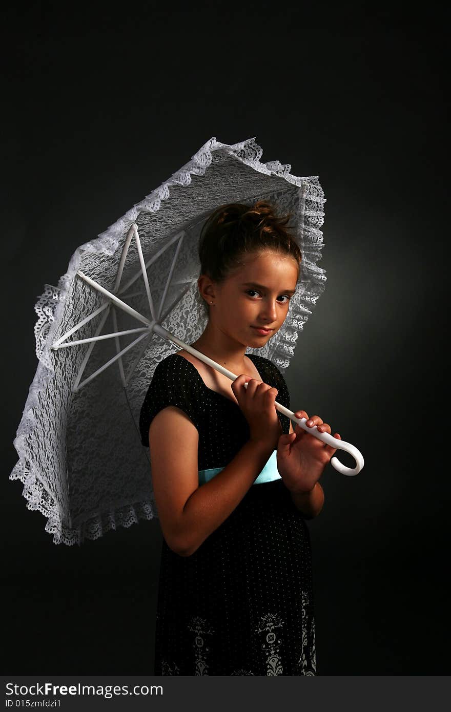 Pretty young girl holding white parasol and a serious expression on her face. Pretty young girl holding white parasol and a serious expression on her face