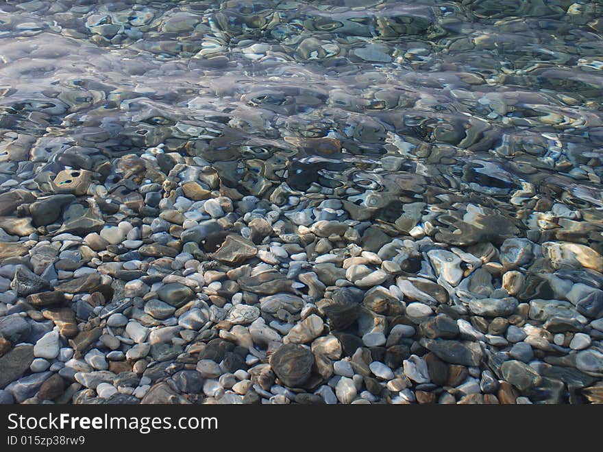 You can see the stones in clean sea. You can see the stones in clean sea