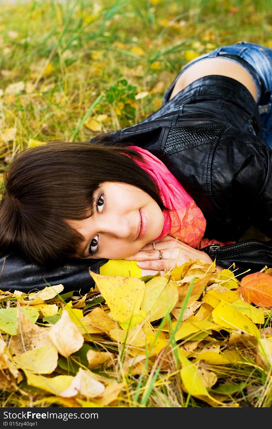 Beautiful girl relaxing in the park on the grass