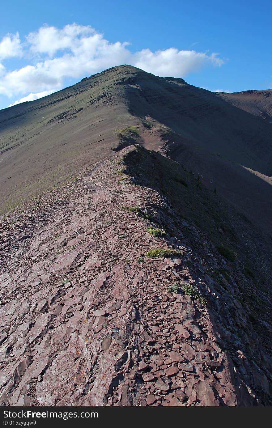 A red color mountain peak on Carthew-Alderson Trail in Waterton National Park Alberta Canada. A red color mountain peak on Carthew-Alderson Trail in Waterton National Park Alberta Canada