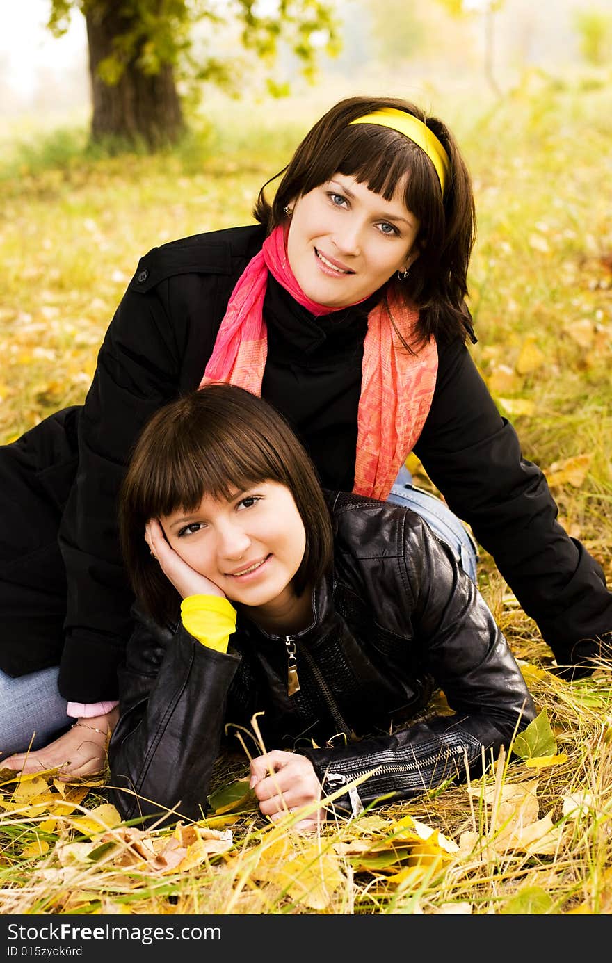 Two girls on the grass in the park