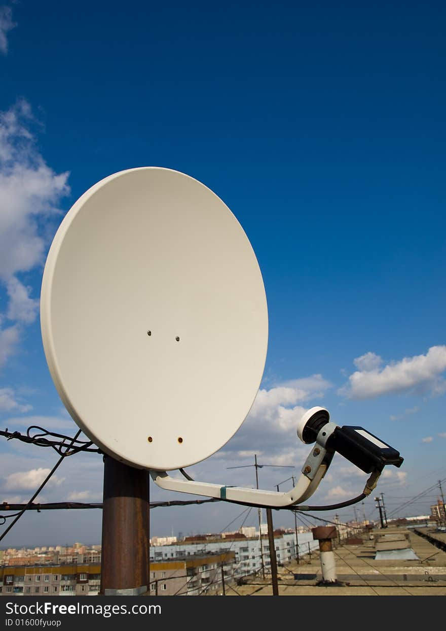 Antenna on a roof over blue sky