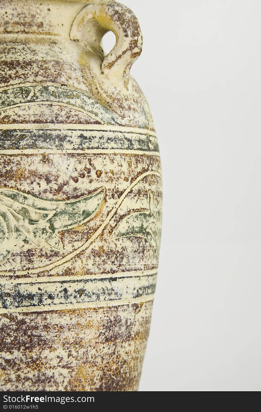 A close up of an old ceramic vase on a white backround. A close up of an old ceramic vase on a white backround.