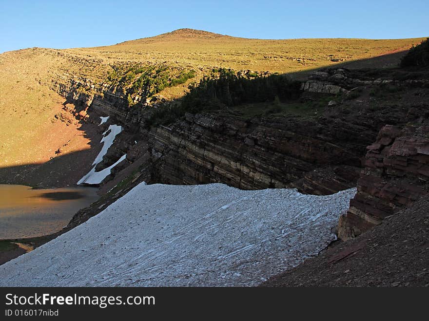 Snow residue surrounded by colorful rocks