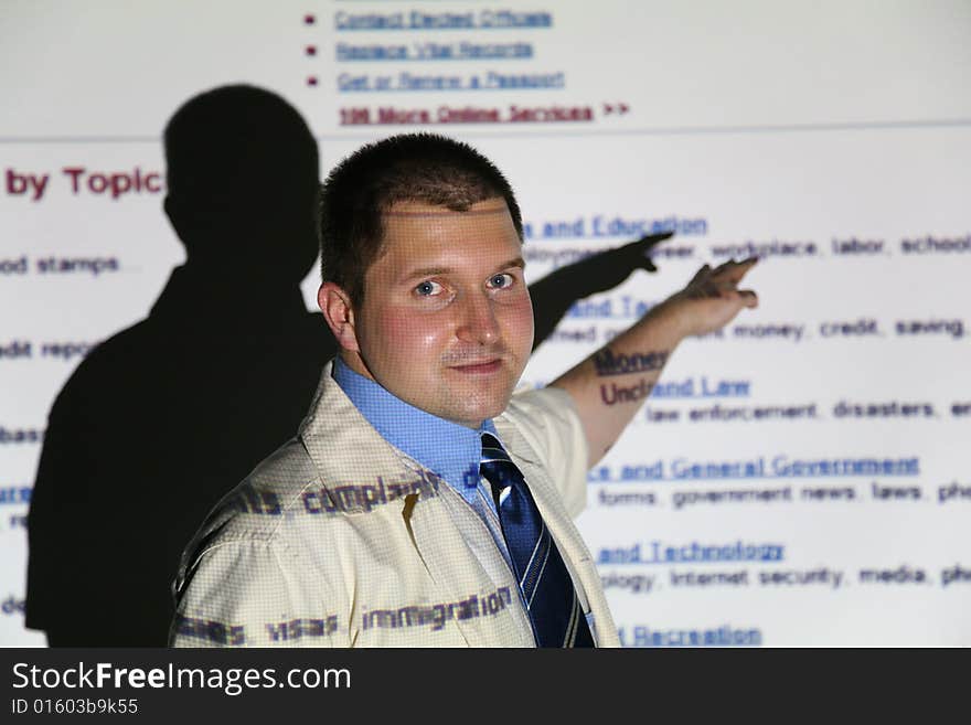 Businessman on light of screen shows  text. Businessman on light of screen shows  text