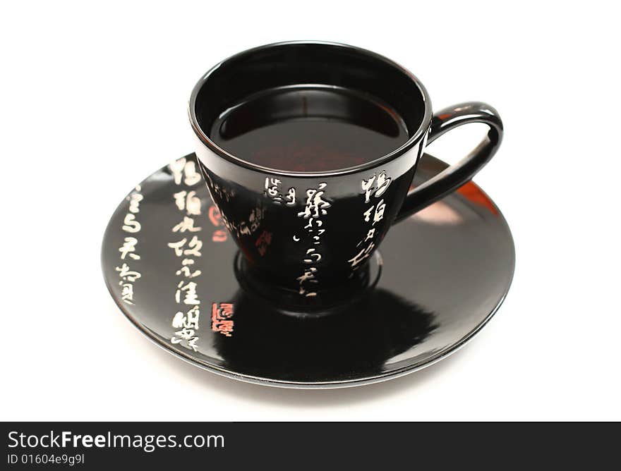 Black cup of tea on awhite background