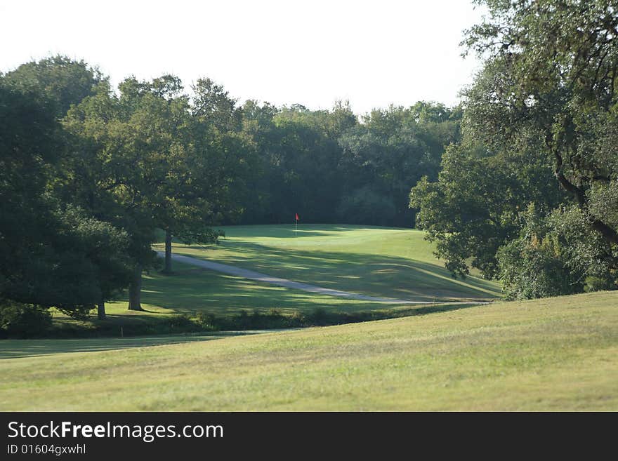 A view of the green on a scenic hill country golf course. A view of the green on a scenic hill country golf course