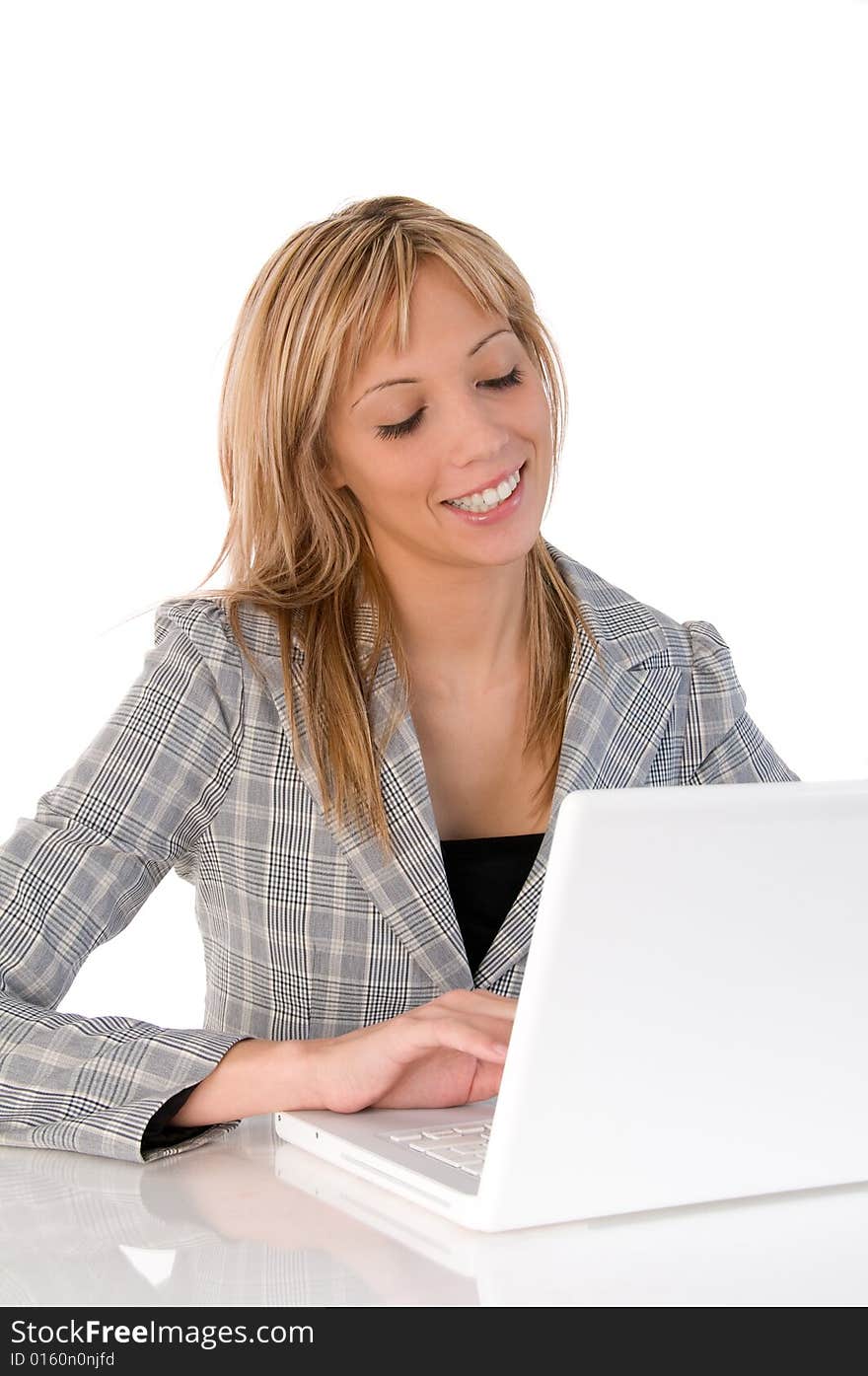 Portrait of confident business woman sitting at the table and typing a document on the laptop. Portrait of confident business woman sitting at the table and typing a document on the laptop