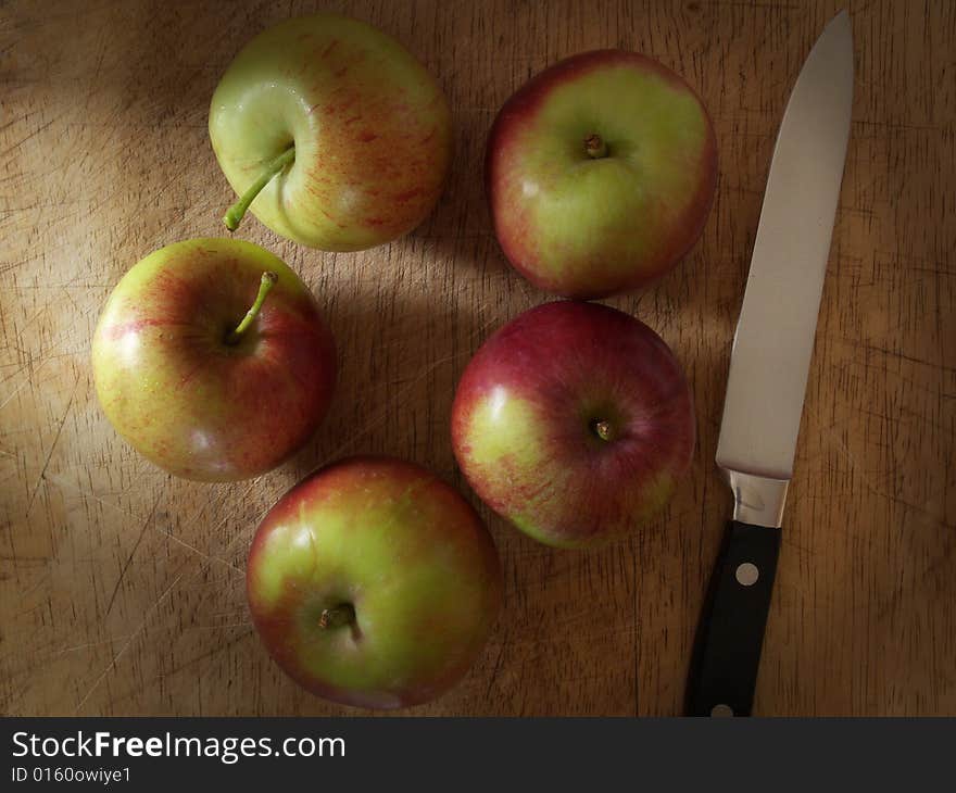 Apples And Knife On Old Chopping Board.