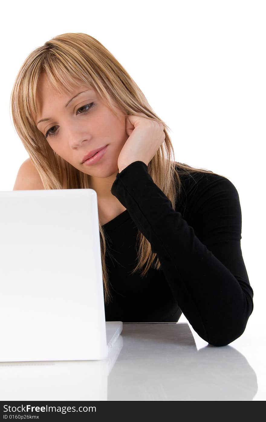 Closeup portrait of a young woman concentrated using laptop. On white background