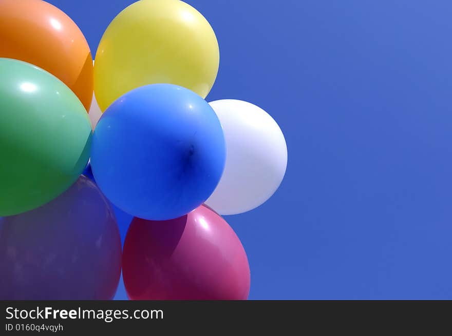 Vibrant bold balloons against a bright blue sky. Vibrant bold balloons against a bright blue sky