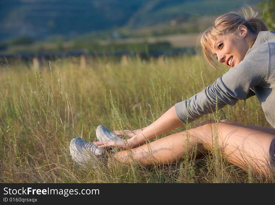 Beautiful young woman stretching