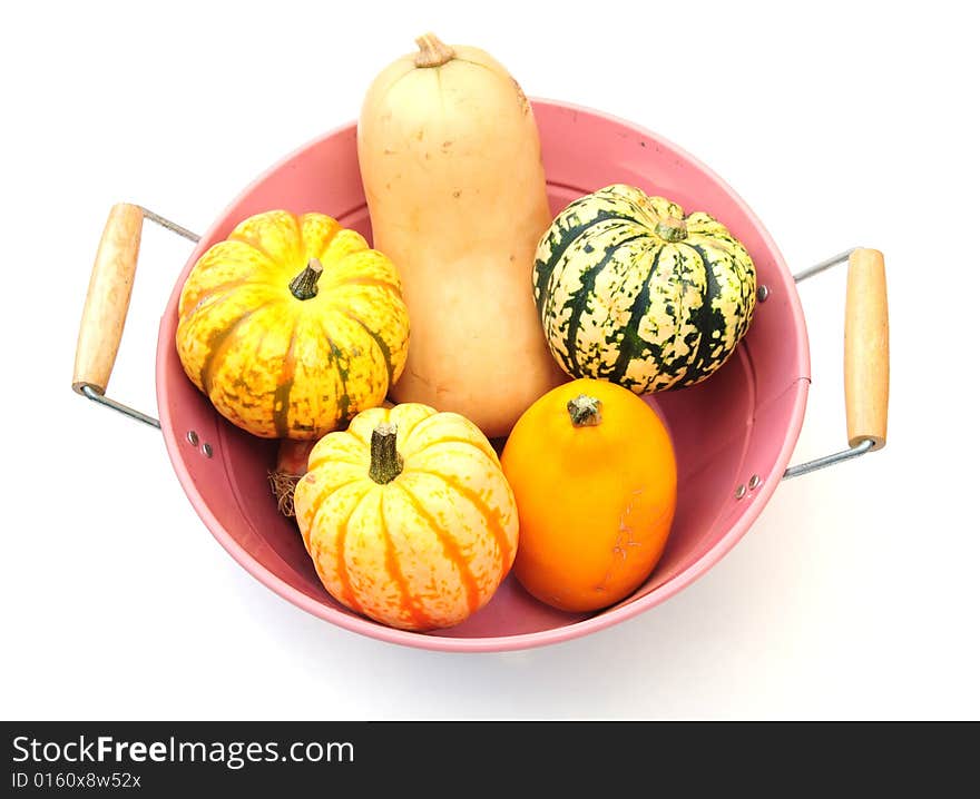 A shot of some fresh seasonal squashes on white